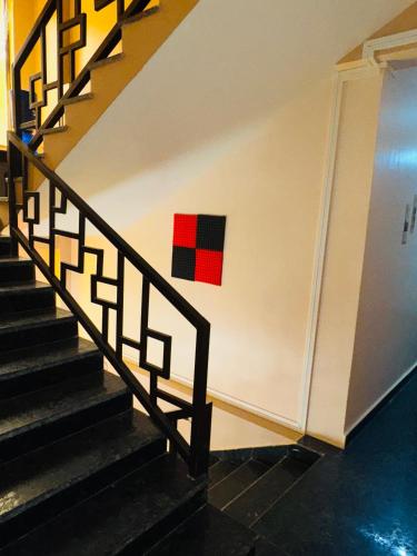 a staircase with a red squares on the wall at XTSY Travellers Hostel in Shillong