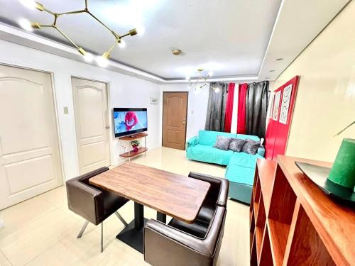 a living room with a table and a couch at One Oasis 2BR beside SM City Mall upto 6pax in Davao City