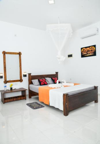 a bedroom with two beds and a mirror at Eco Friendly Lodge in Udawalawe