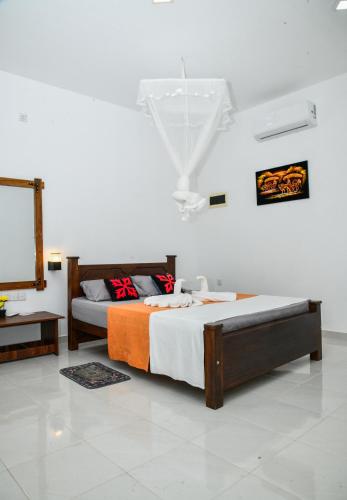 a bedroom with two beds and a mirror on the wall at Eco Friendly Lodge in Udawalawe