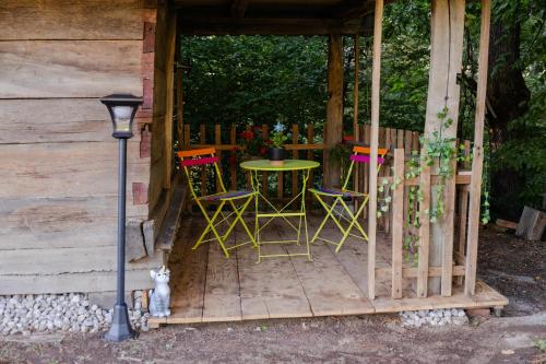 a patio with a table and chairs in a cabin at Kozline Kordun in Veljun