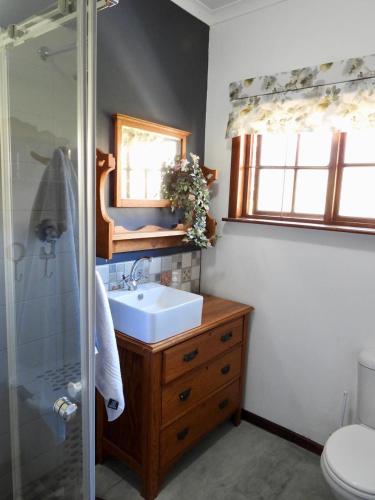 a bathroom with a sink and a shower at Sedgefield Vacation Home in Sedgefield