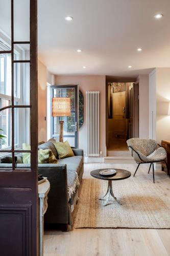 a living room with a couch and a table at Green Maison Westfield in London