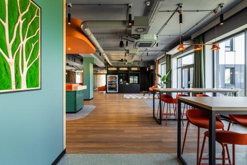 an office corridor with tables and chairs and a cafeteria at DeSilva Inn Opole in Opole