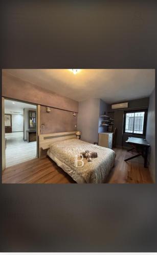 a bedroom with a bed and a table in it at Chez Carole in Rose Hill