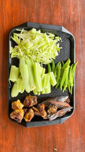 a plastic container filled with vegetables on a table at Lombok Grace Bungalows in Tetebatu