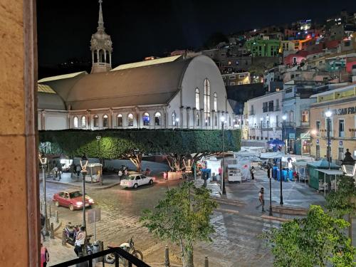 a view of a city at night with a building at H san Carlo suite in Guanajuato