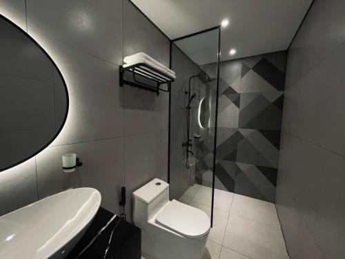 a bathroom with a toilet and a glass shower at LION 17 Hotel in Can Tho