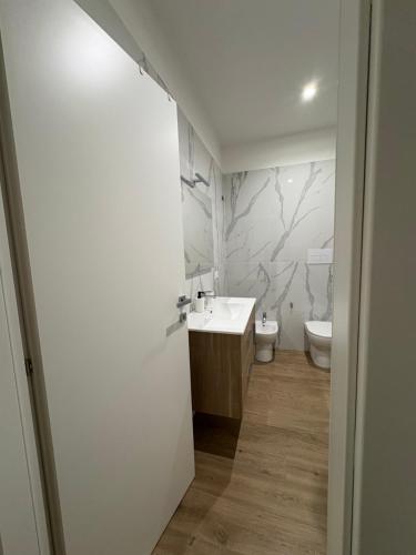 a bathroom with a sink and a toilet at Binario623 in Reggio Calabria