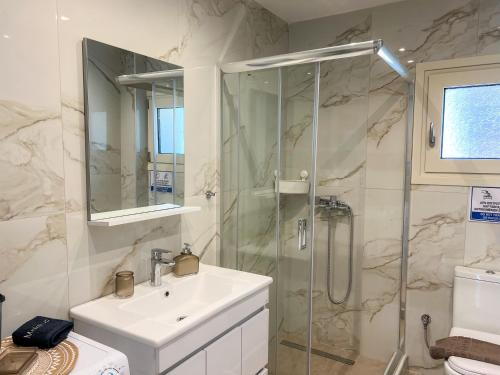a bathroom with a sink and a shower at Magda's Cosy House Fourka in Fourka