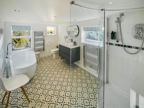 a bathroom with a tub and a sink and a shower at Greycott - Uk48746 in Crantock