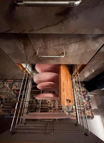 a stack of pink chairs in a drying rack at Visla Stay Service Apartment near DLF Newtown in Bengaluru