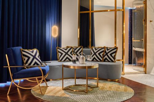 a living room with a table and two chairs at OKU Hotel in Taichung