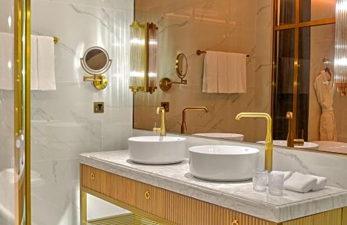 two sinks on a counter in a bathroom at OKU Hotel in Taichung