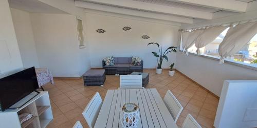 a living room with a couch and a table at Case Vacanza Torre Canne in Torre Canne