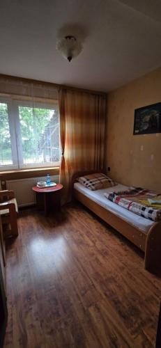 a room with two beds and a table in it at Gospodarstwo Agroturystyczne Agroletnica in Świdnica