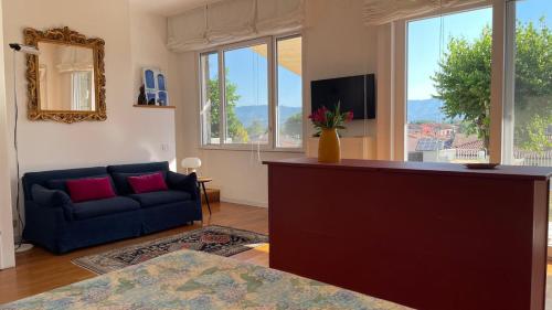 a living room with a blue couch and a tv at plumbago blue in Ameglia