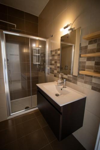 a bathroom with a sink and a shower at Gajdoru Valley apartment in Xagħra