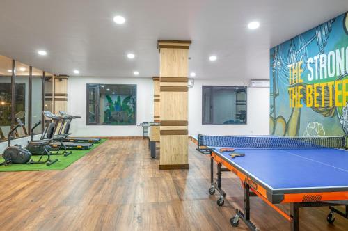 a gym with a ping pong table and exercise equipment at Mystique Mayong Resort in Rāja Māyang