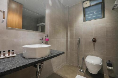 a bathroom with a sink and a toilet at Enrise by Sayaji, Khed Shivapur Pune in Pune