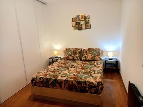 a bedroom with a bed and two lamps on two tables at T5 L'ATELIER in Valence-dʼAgen