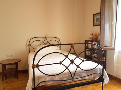 a bedroom with a metal bed with a table at Villa Petri in Petra