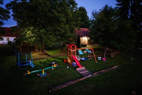 a backyard with a playground in the grass at Kozline Kordun in Veljun