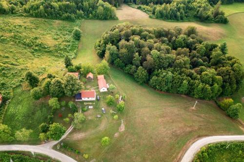 an aerial view of a house on a field with trees at Kozline Kordun in Veljun