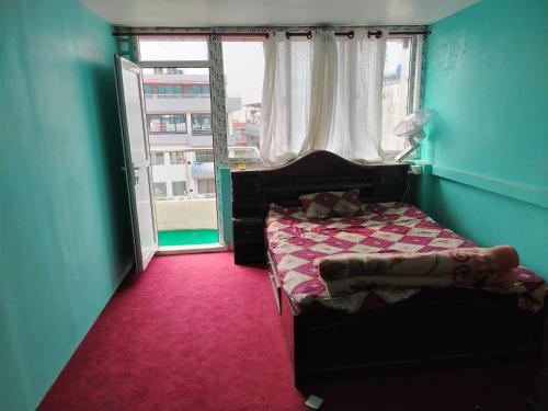 a small bedroom with a bed and a window at Puru Boutique Home "PBH", Private Room, Apartment, Thamel, Swoyambhu, Benchen Monastery, Kathmandu, Nepal in Kathmandu