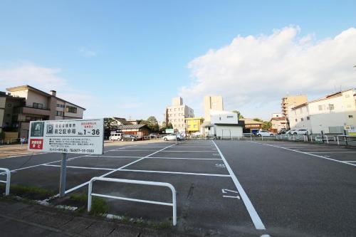 an empty parking lot with a sign in the middle at Country Hotel Takayama in Takayama