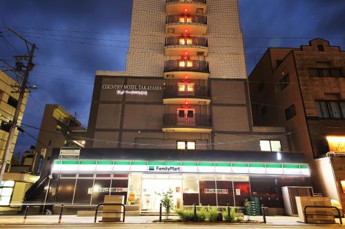 a building with a sign on top of it at Country Hotel Takayama in Takayama