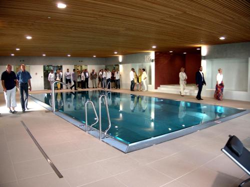 a group of people standing around a swimming pool at Hotel S-PORT Véska in Dolany