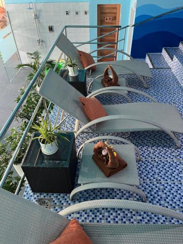 a group of chairs and tables on a balcony at 88th Avenue in Cebu City