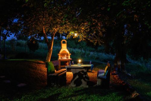 a table with a light on it under a tree at Kozline Kordun in Veljun