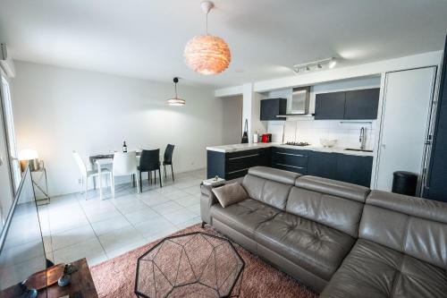 a living room with a couch and a kitchen at Spacious apartment in Talence in Talence