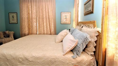 a bedroom with a bed with pillows on it at 12 Pearls in Cape May Point