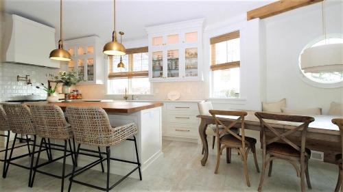 a kitchen with a wooden table and chairs at 12 Pearls in Cape May Point