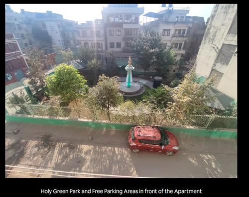 a red car is parked in front of a fountain at Puru Boutique Home "PBH", Private Room, Apartment, Thamel, Swoyambhu, Benchen Monastery, Kathmandu, Nepal in Kathmandu
