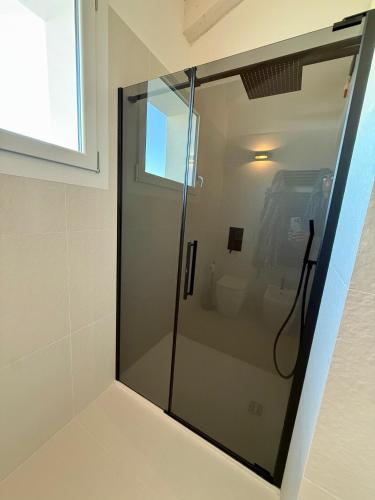 a shower in a bathroom with a glass door at Luxury Beach and Pool House Jesolo in Lido di Jesolo