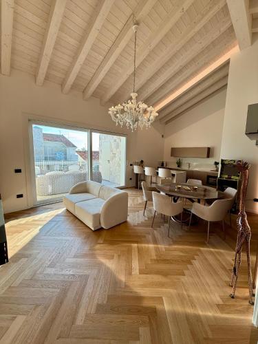a living room with a white couch and a table at Luxury Beach and Pool House Jesolo in Lido di Jesolo