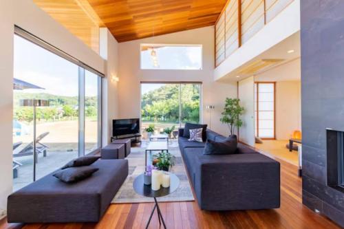 a living room with two couches and a tv at Futtsu Kodate FK1 in Futtsu
