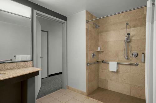 a bathroom with a shower with a glass door at Courtyard Pittsburgh Settlers Ridge/Robinson Township in Robinson Township