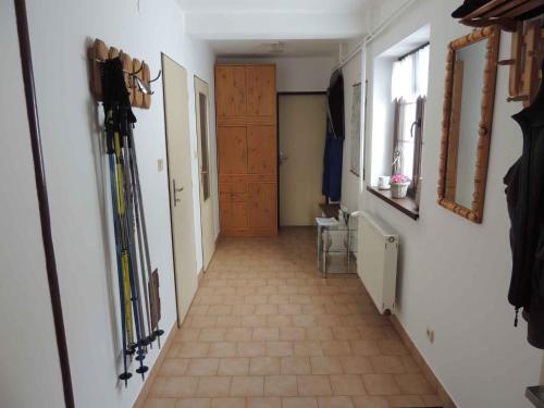 a hallway with skis on the wall and a door at Holiday home Sedlonov - Adlergebirge 949 in Sedloňov