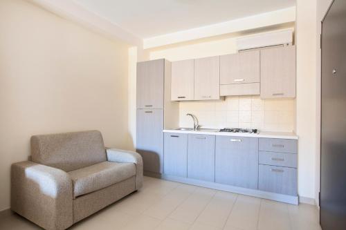 a kitchen with a chair and a sink at Hotel San Martino in Cassibile