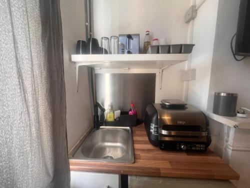 a kitchen with a sink and a toaster on a counter at East Suite in London