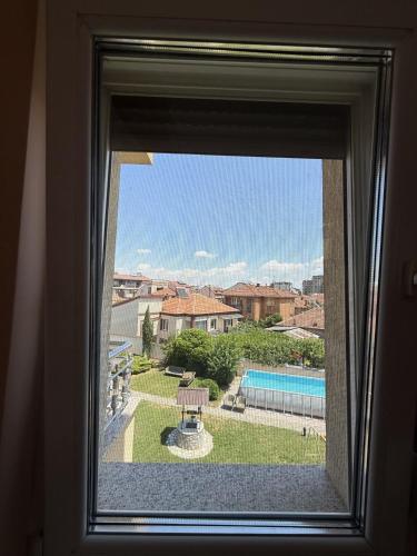 a window with a view of a swimming pool at Orion Luxury Apartments in Bitola