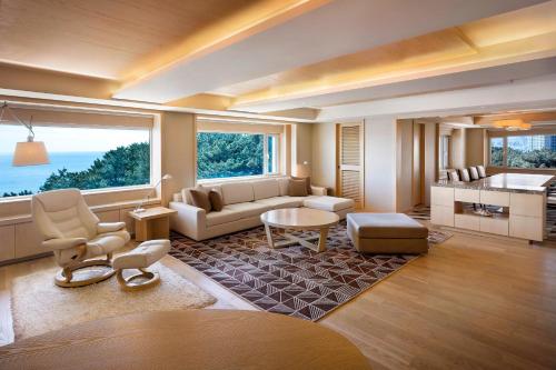 a living room with a couch and a table at The Westin Josun Busan in Busan