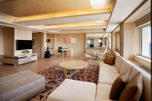 a living room with a couch and a table at The Westin Josun Busan in Busan