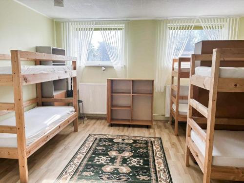 a room with several bunk beds and a rug at UKU Villa in Tallinn