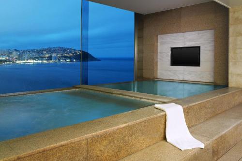 a jacuzzi tub with a view of the water at The Westin Josun Busan in Busan